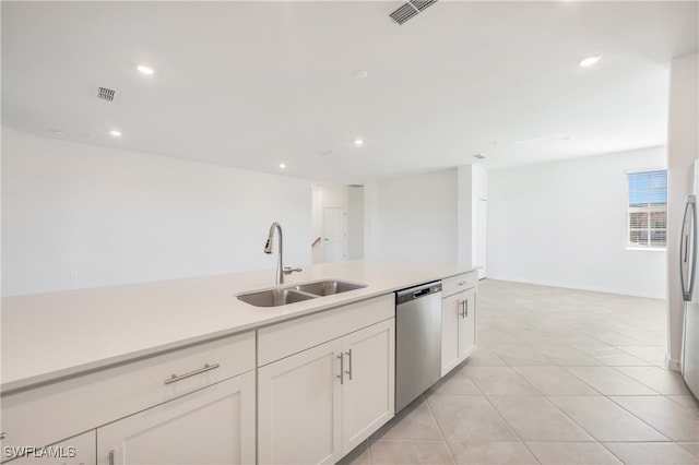 kitchen featuring white cabinets, light tile patterned floors, stainless steel appliances, and sink