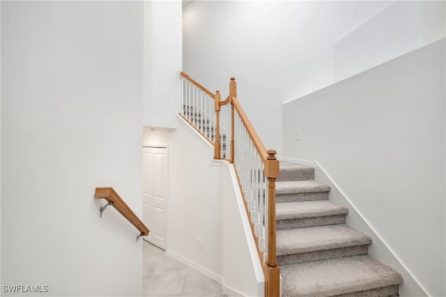 stairway with tile patterned floors