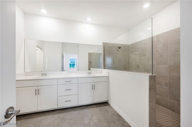 bathroom with vanity and tiled shower