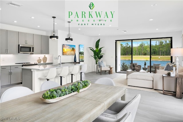 dining room featuring sink and a water view