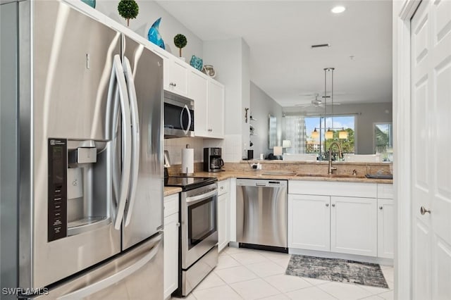 kitchen with white cabinetry, ceiling fan, sink, light tile patterned flooring, and appliances with stainless steel finishes