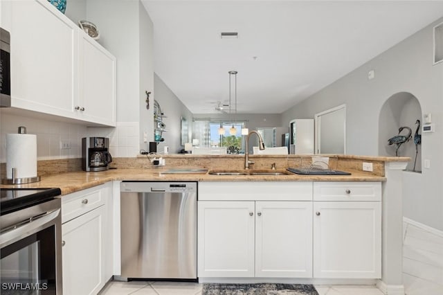 kitchen with kitchen peninsula, white cabinetry, sink, and stainless steel appliances