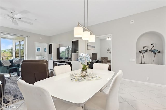 tiled dining area featuring ceiling fan