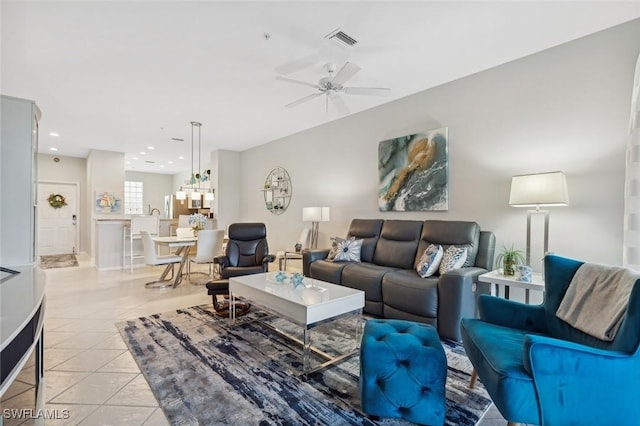 living room with ceiling fan and light tile patterned flooring