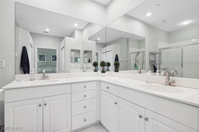 bathroom featuring tile patterned flooring, vanity, and walk in shower