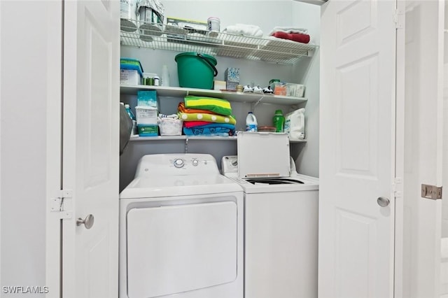 clothes washing area featuring independent washer and dryer