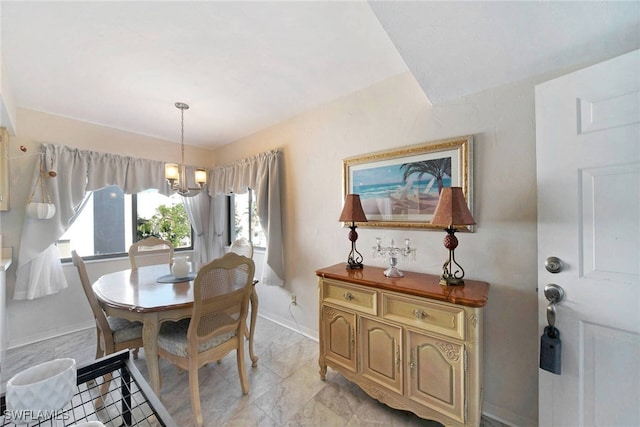 dining area featuring an inviting chandelier