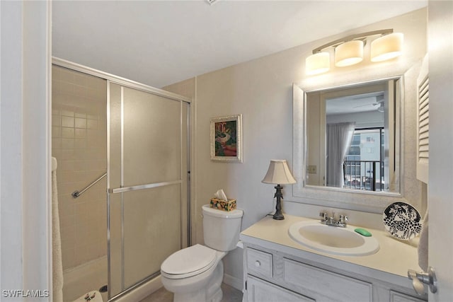 bathroom with vanity, toilet, and a shower with shower door