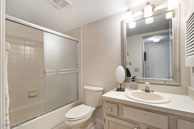 full bathroom with vanity, toilet, and bath / shower combo with glass door