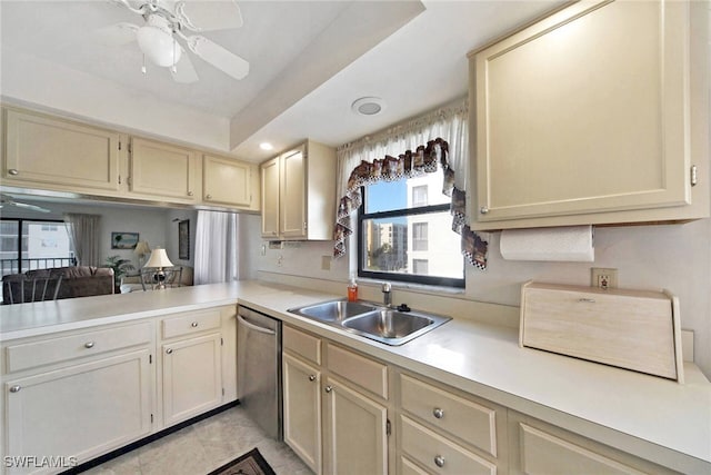 kitchen with ceiling fan, sink, stainless steel dishwasher, and cream cabinetry