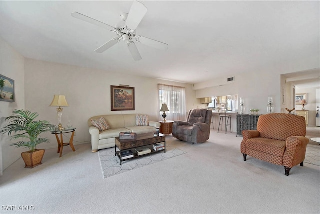 living room featuring ceiling fan and light colored carpet