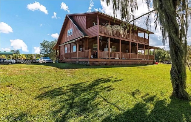 rear view of property featuring a lawn