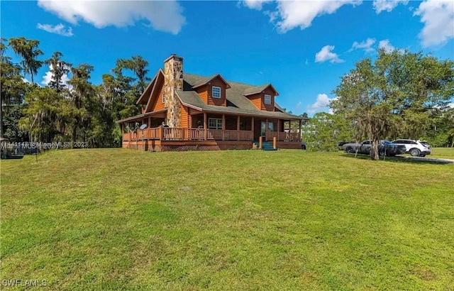 rear view of house with a lawn