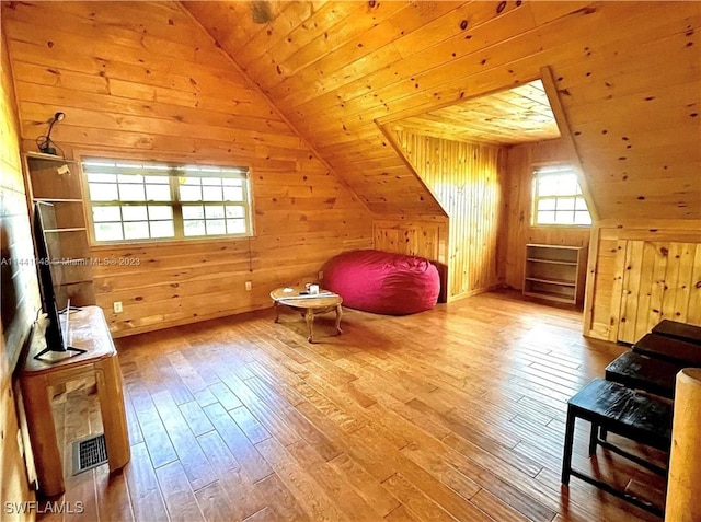 bonus room with wood walls, wood-type flooring, and wooden ceiling