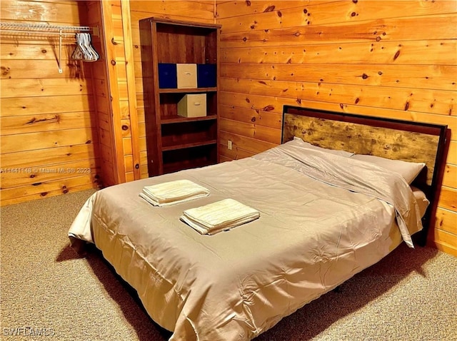 bedroom featuring carpet floors and wooden walls