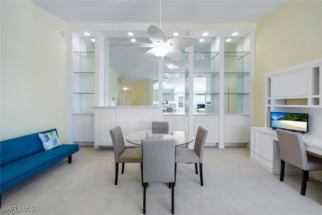 dining room featuring ceiling fan and light colored carpet