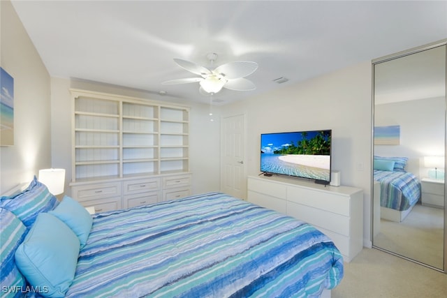 bedroom with ceiling fan and light carpet