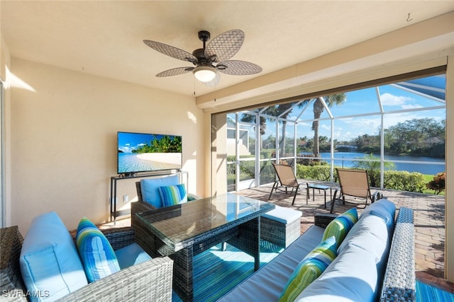 view of patio with an outdoor hangout area, glass enclosure, and ceiling fan