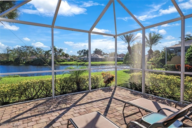 unfurnished sunroom featuring a water view