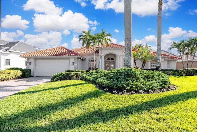 mediterranean / spanish-style house with a front yard and a garage