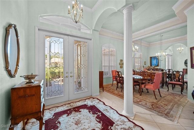 tiled foyer entrance featuring ornate columns, french doors, and ornamental molding