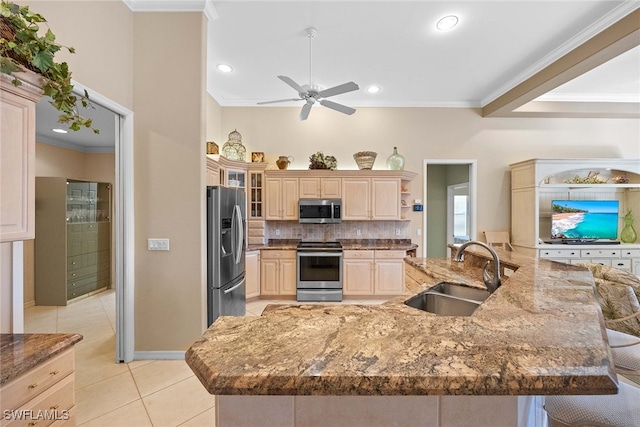 kitchen featuring a breakfast bar, sink, light tile patterned floors, ornamental molding, and stainless steel appliances