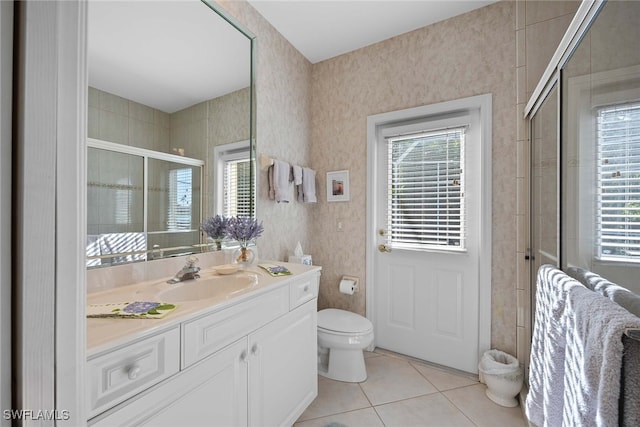 bathroom featuring vanity, tile patterned floors, an enclosed shower, and a healthy amount of sunlight