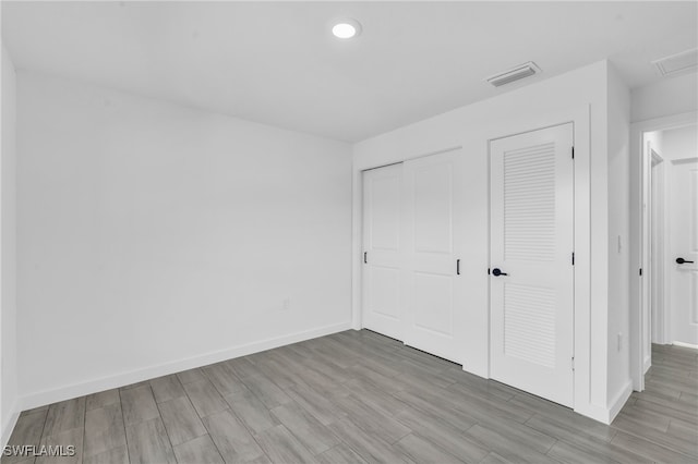 unfurnished bedroom with light wood-type flooring