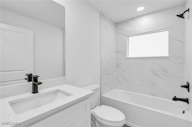 full bathroom with vanity, toilet, and tiled shower / bath