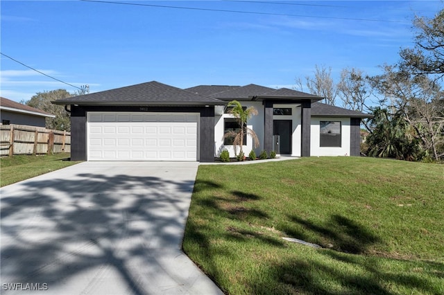 prairie-style house featuring a front lawn and a garage