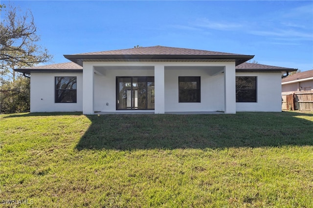 rear view of house with a lawn