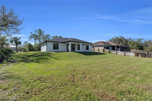 rear view of property with a yard