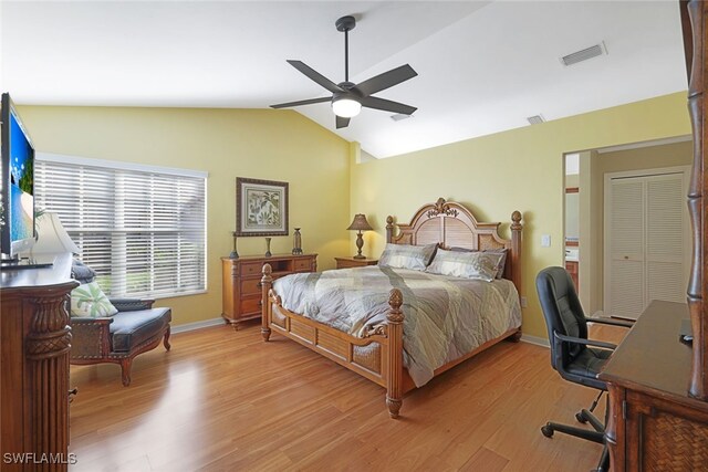 bedroom featuring a closet, light hardwood / wood-style flooring, ceiling fan, and lofted ceiling