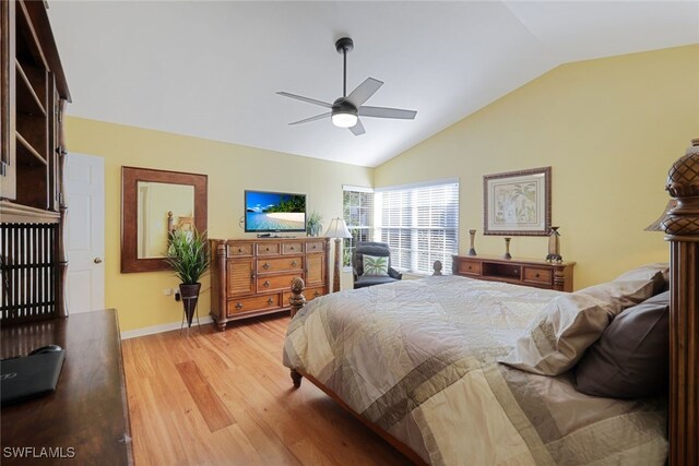 bedroom with ceiling fan, light hardwood / wood-style flooring, and vaulted ceiling