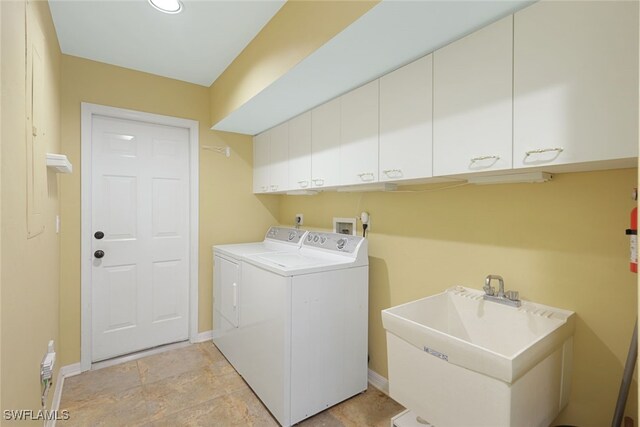 washroom featuring cabinets, washer and dryer, and sink