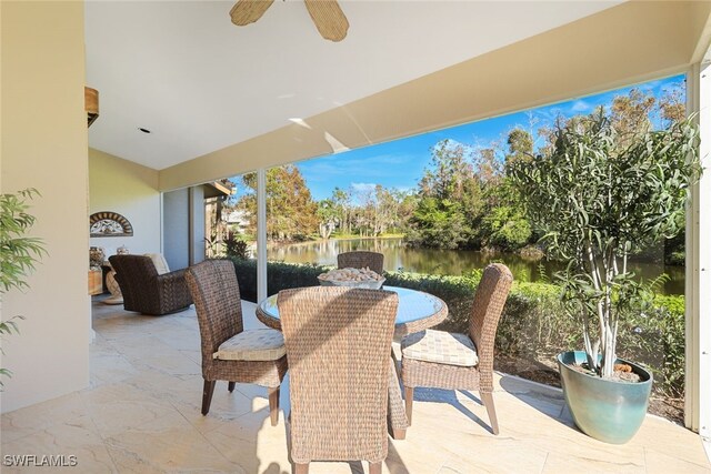 view of patio / terrace featuring ceiling fan and a water view