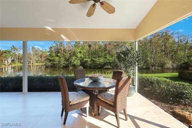 view of patio with ceiling fan and a water view