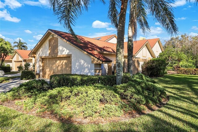 view of front of property with a front yard and a garage