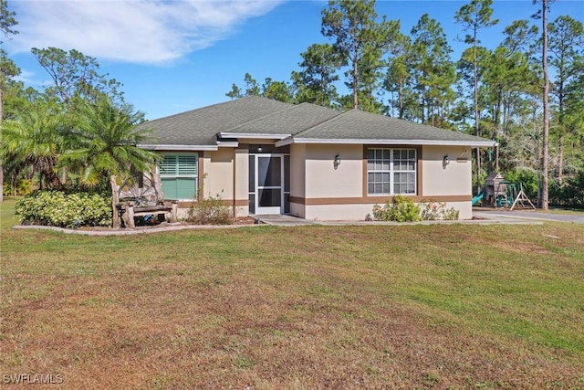 ranch-style home with a front lawn and a playground