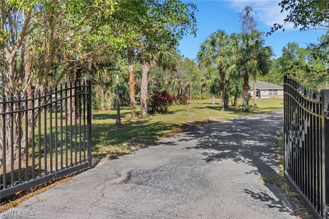 view of gate with a lawn