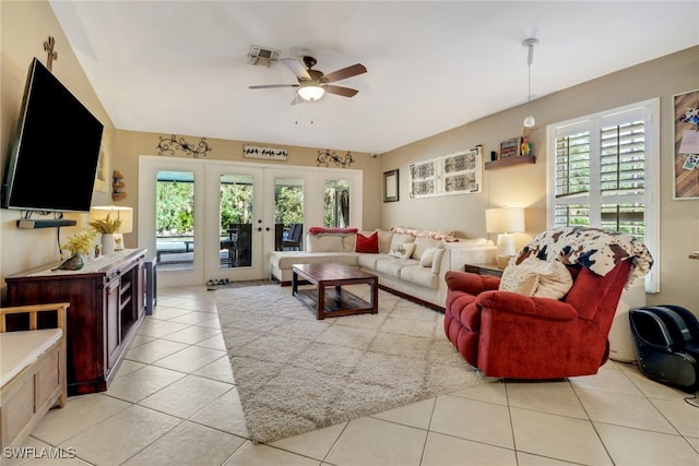 living room featuring light tile patterned floors, ceiling fan, and french doors