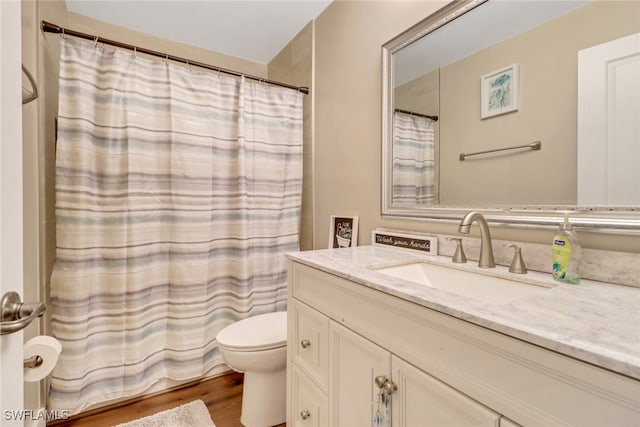 bathroom with vanity, hardwood / wood-style floors, and toilet