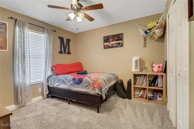 bedroom featuring multiple windows, ceiling fan, and carpet flooring