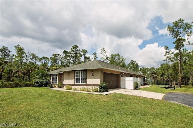 ranch-style home with a front lawn and a garage