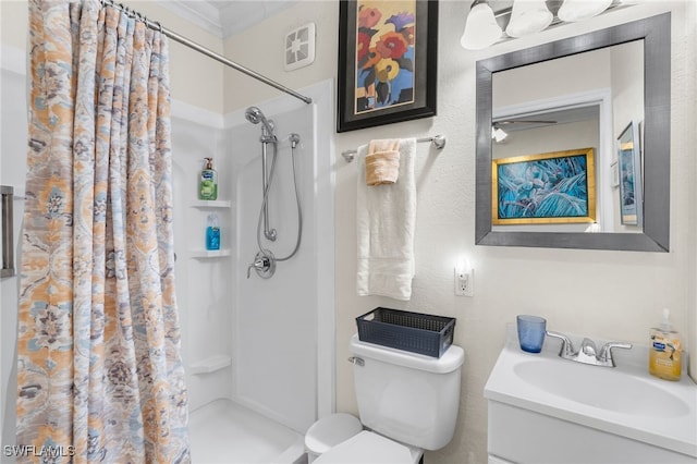 bathroom featuring curtained shower, vanity, and toilet