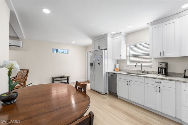 kitchen with white cabinets, sink, white refrigerator with ice dispenser, dishwasher, and light hardwood / wood-style floors