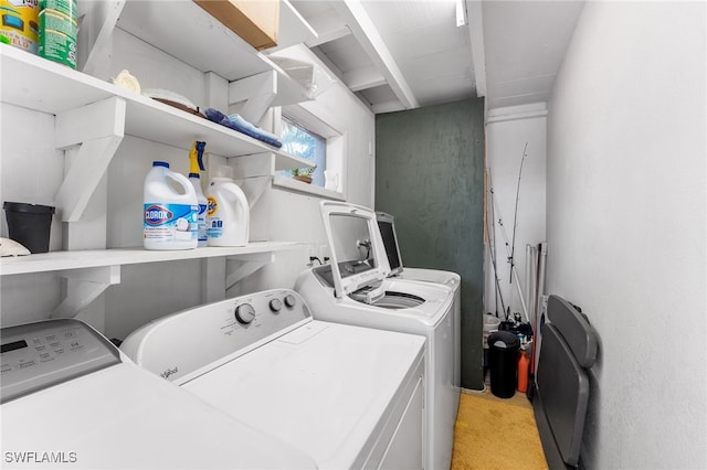 laundry room with light carpet and washer and clothes dryer