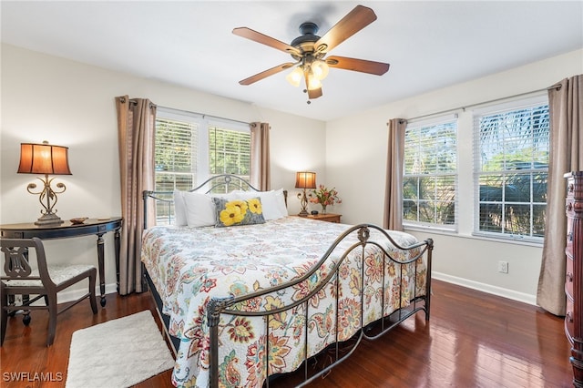 bedroom with dark hardwood / wood-style floors and ceiling fan