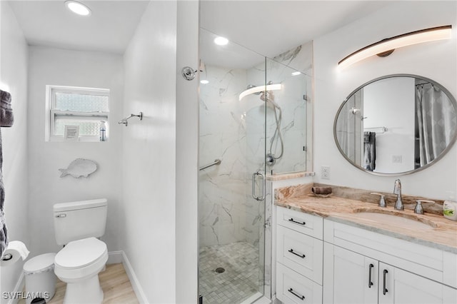 bathroom with hardwood / wood-style flooring, vanity, toilet, and walk in shower