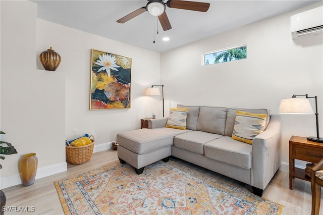 living room featuring ceiling fan, light hardwood / wood-style flooring, and a wall mounted AC